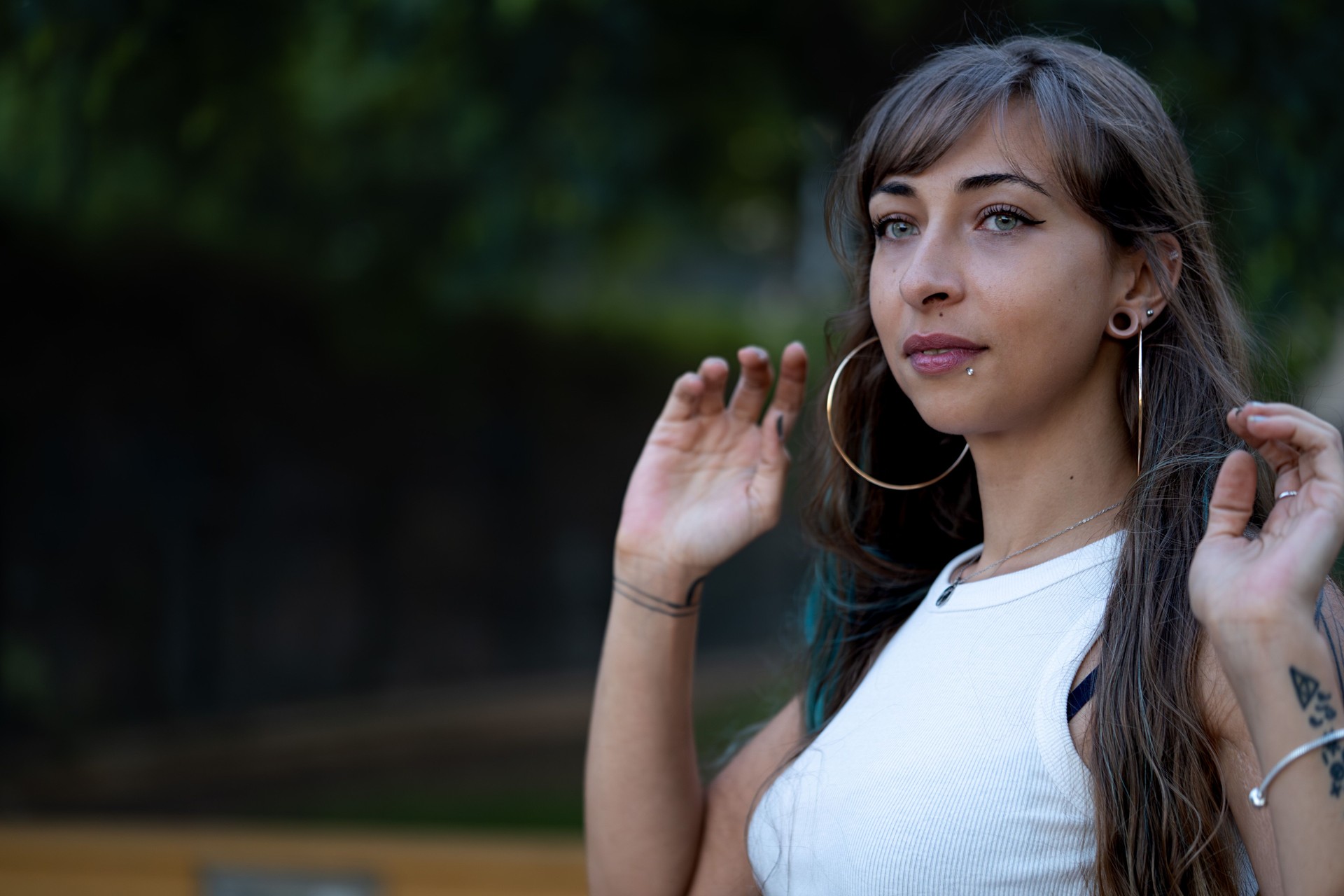 Young woman with piercings posing outdoors